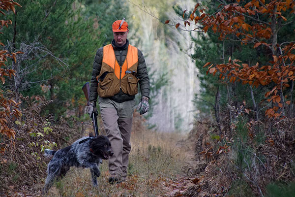 DNR Director Dan Eichinger is shown on a hunting walk with his dog.