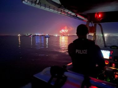 ECO on patrol boat, fireworks in the distance