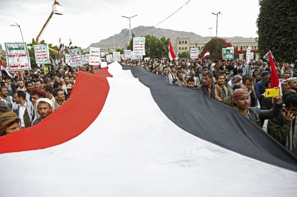 FILE - Houthi supporters chant slogans holding signs reading "Death to America, Death to Israel", as they attend a rally marking eight years for a Saudi-led coalition, Friday, March 26, 2023, in Sanaa, Yemen. For years, the Houthi rebels controlling northern Yemen have chanted slogans at their mass rallies calling for the destruction of Israel. But they never joined any conflict beyond the confines of their own country’s civil war or nearby in the Arabian Peninsula. The Iranian-backed Shiite Muslim force has launched at least six drone and missile attacks toward southern Israel since the Israel-Hamas war began on Oct. 7. (AP Photo/Hani Mohammed, File)