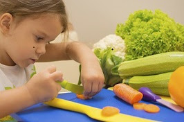 young girl preparing vegetables