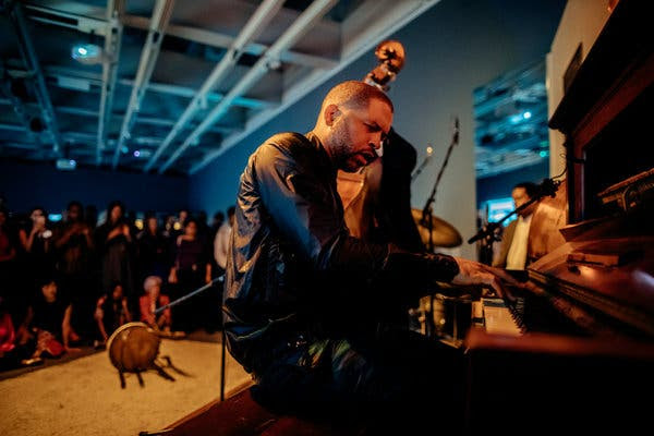 Jason Moran performing with his trio, the Bandwagon, at the Whitney Museum of American Art. Performance is as much a part of his exhibition as his sculptures and drawings.