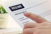 Photo of hand pointing at resume