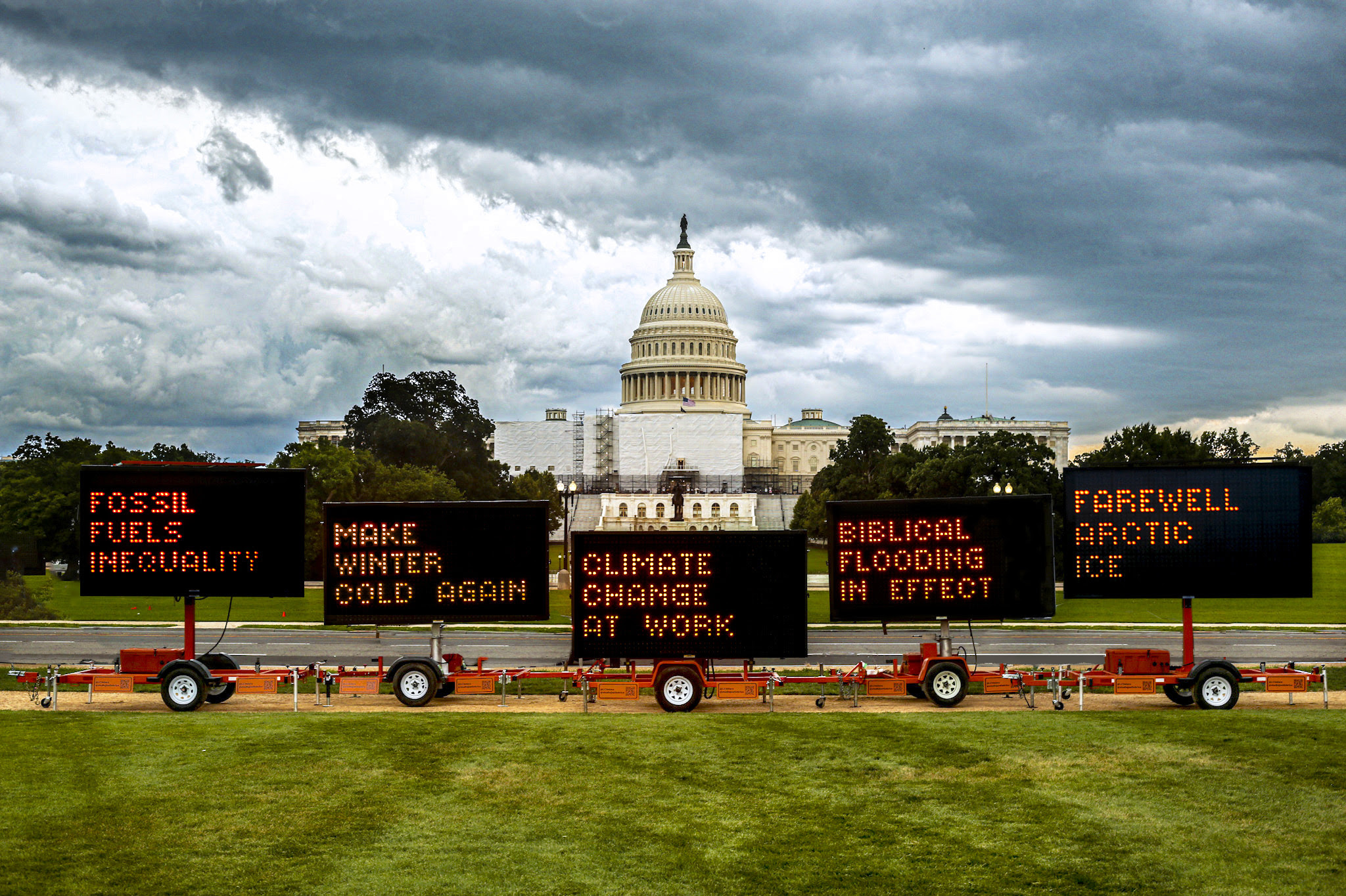 Solar-powered highway road signs on the National Mall urging people to engage on climate action.