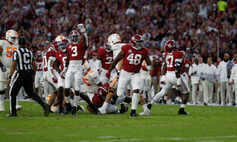 Alabama defensive players celebrate a fourth down stop versus Tennessee