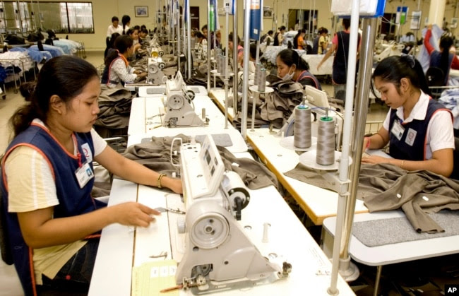 FILE - Cambodian garment workers sew clothes in a factory in Phnom Penh, Cambodia, Aug. 4, 2007.