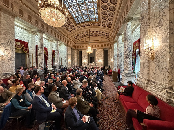 A large crowd gathers in an ornate ballroom to celebrate more than 10 years of same-sex marriage and marriage equality in Washington.