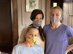 Three women wearing homemade face masks