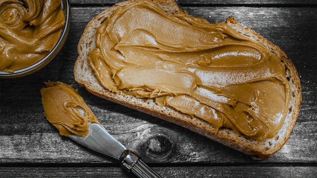 Peanut butter spread on a slice of bread