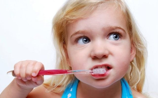 Illustrative. Child brushing her teeth.