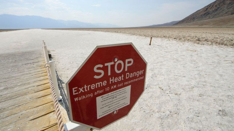 Signage warns of extreme heat danger at the salt flats of Badwater Basin inside Death Valley National Park
