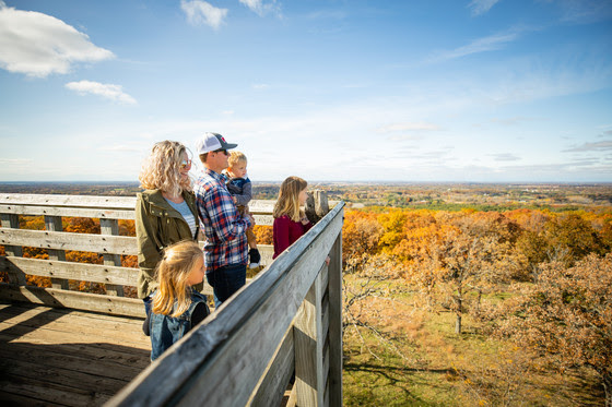 Family on Observation Tower Overlooking trees that Lapham Peak 