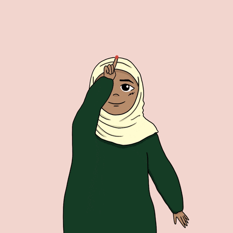 A woman in a hijab drawing a heart
