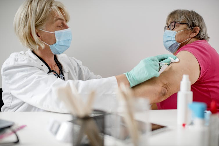 A woman receives a COVID-19 shot.