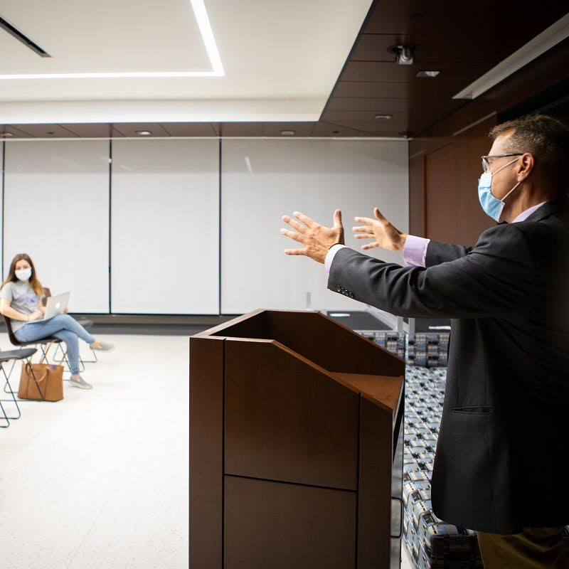 Students and a professor demonstrate current physical distancing and face covering best practices in a classroom in Capen Hall in July 2020