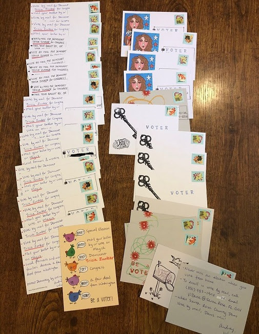 A table covered with ready to mail, colorful postcards.