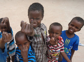 Children in Kenya show their marked fingers after being vaccinated against polio 