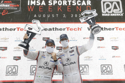 Helio Castroneves and Ricky Taylor celebrate their win Sunday at Road America in Elkhart Lake, Wisconsin. (PRNewsfoto/Acura Motorsports)