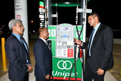 Rahul Rampersad, right, of Harkness Energy, explains the workings of the CNG pump to President of NGC CNG Curtis Mohammed, left, and Unipet chairman Dr Afraz Ali.