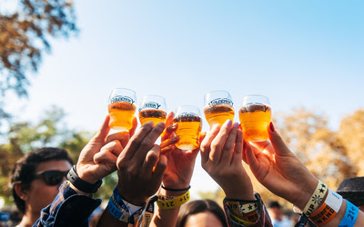 A group of people holding up glasses of beerDescription automatically generated with low confidence