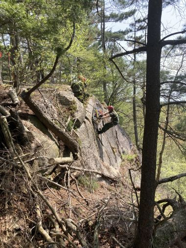 Two Rangers practice rope training off the side of a steep cliff
