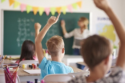 Kids in school raising hands