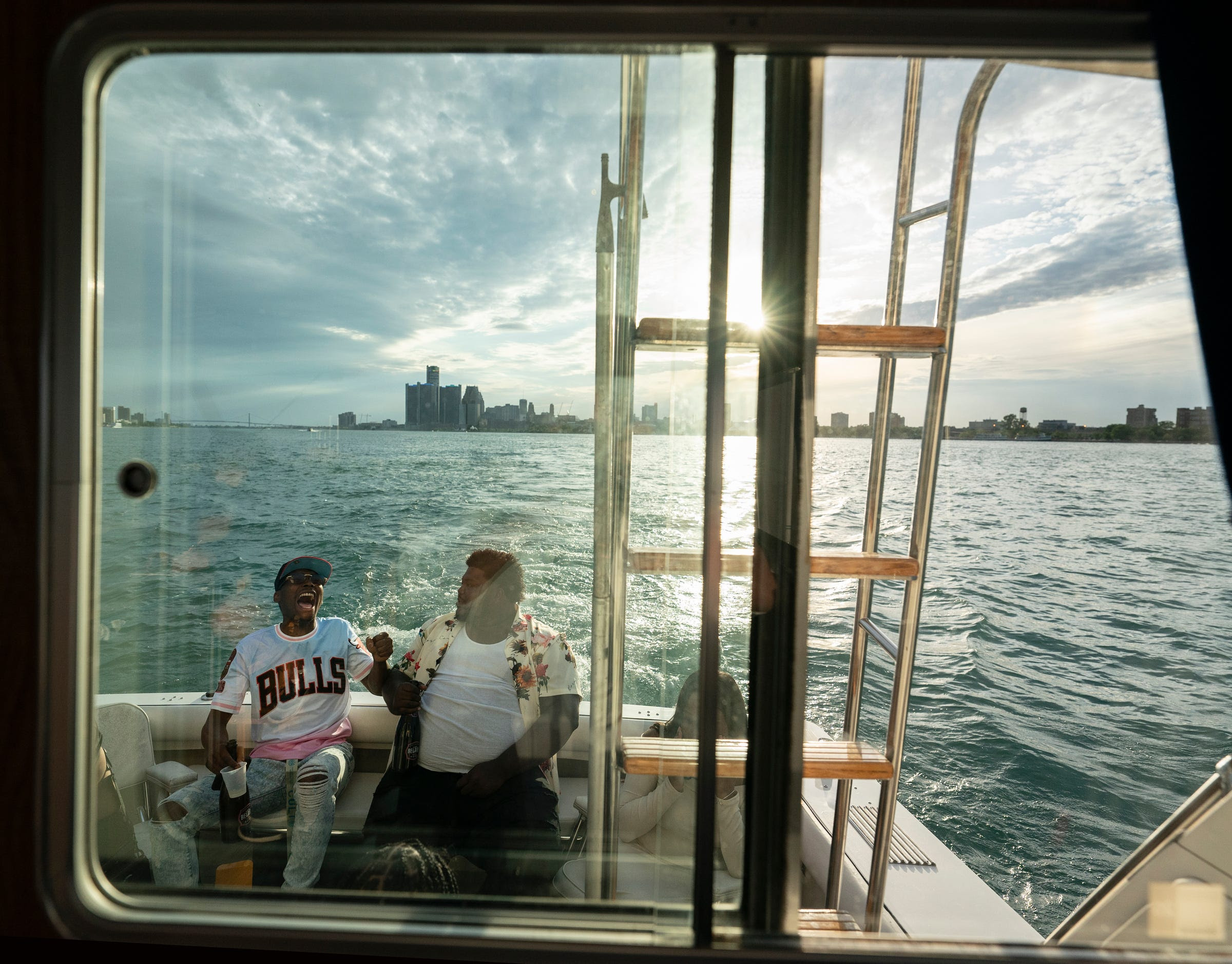 Jalen Miller, 26, of Detroit, left, laughs with Drew Roberts, 26, of Lincoln Park, as they return to the Grayhaven State Harbor marina after chartering a boat through Riverwise Detroit Boat Tours on Saturday, June 4, 2022.