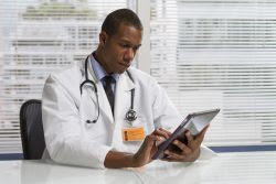 image of a doctor looking at a tablet