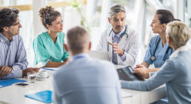 healthcare executives sitting around a table talking