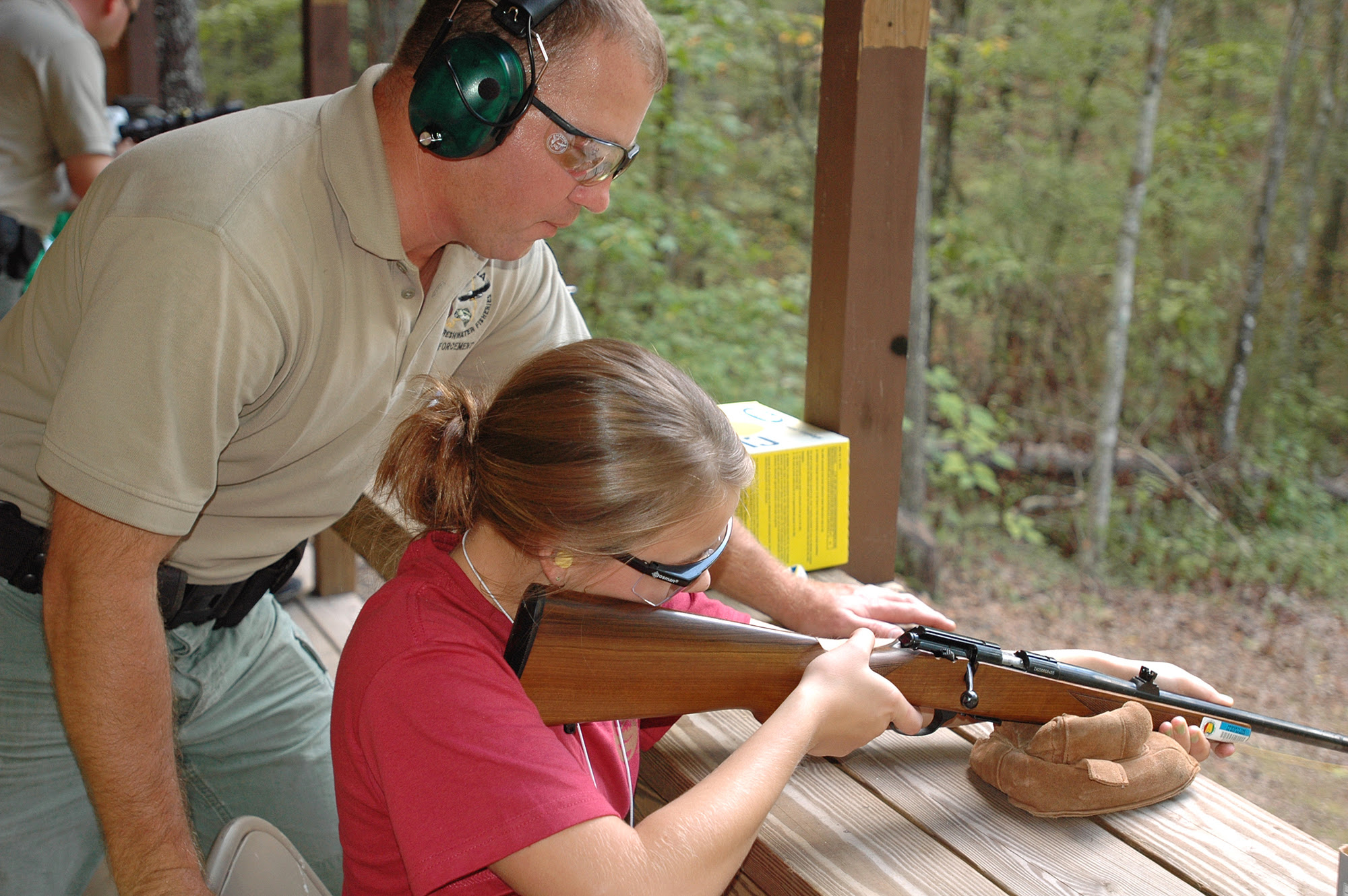 Shooting instructor and student at range