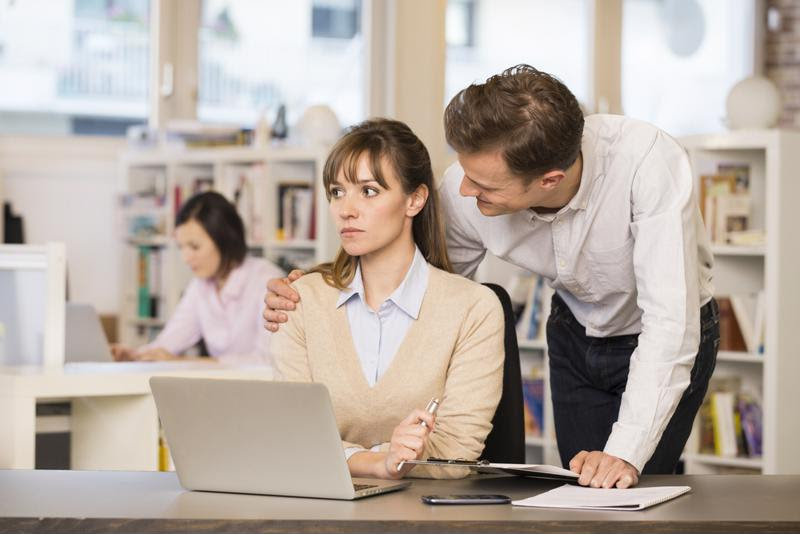 A male employee harasses a female colleague.