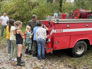 Ranger showing group of kids the type 6 engine