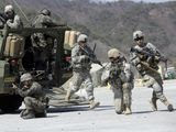 In this March 25, 2015, file photo, U.S. Army soldiers from the 25th Infantry Division&#39;s 2nd Stryker Brigade Combat Team and South Korean soldiers take their positions during a demonstration of the combined arms live-fire exercise as part of the annual joint military exercise between South Korea and the United States at the Rodriquez Multi-Purpose Range Complex in Pocheon, north of Seoul, South Korea. The South Korean and U.S. militaries have postponed on Thursday, Feb. 27, 2020, their annual joint drills out of concerns over a virus outbreak. (AP Photo/Lee Jin-man, File)