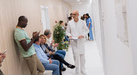 patients waiting in hall to be seen by hospital staff
