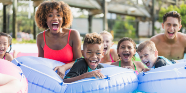 Kids and two adults tubing in summer