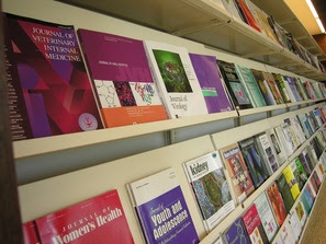 Stock photo of journal magazines on a library rack. 