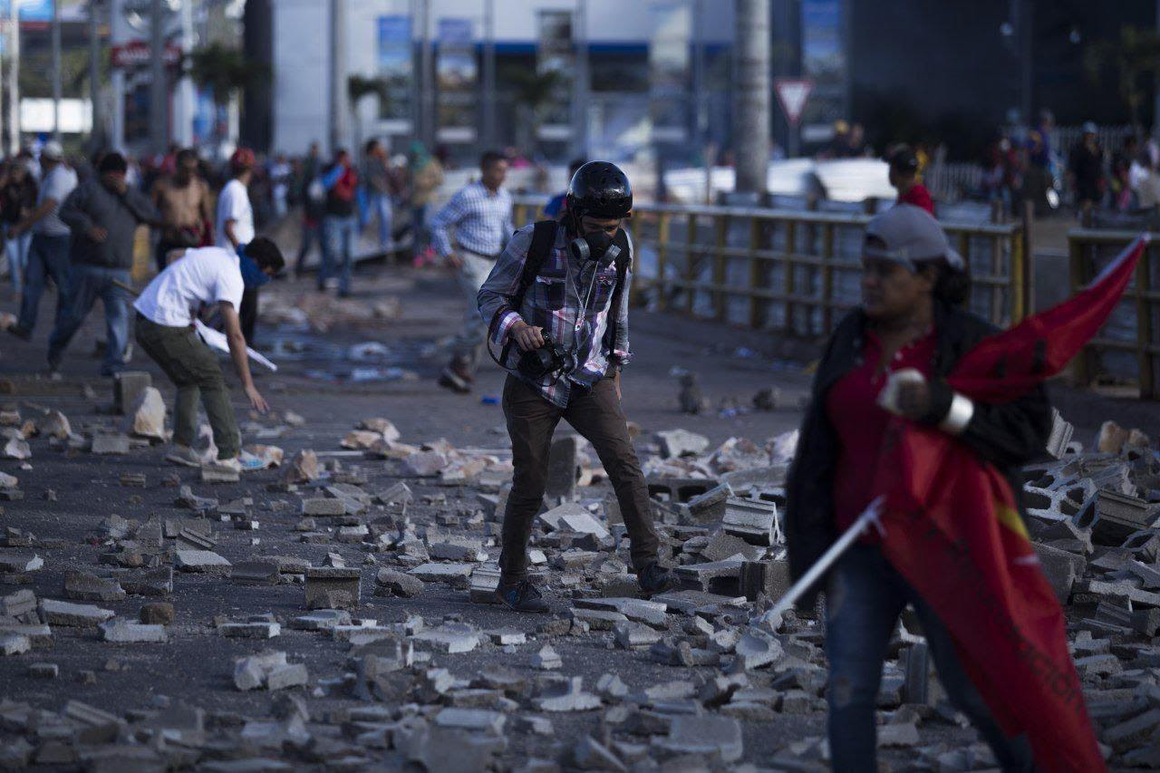 Photojournalist Martín Cálix finds himself the subject of a picture during a protest in Tegucigalpa, Honduras.