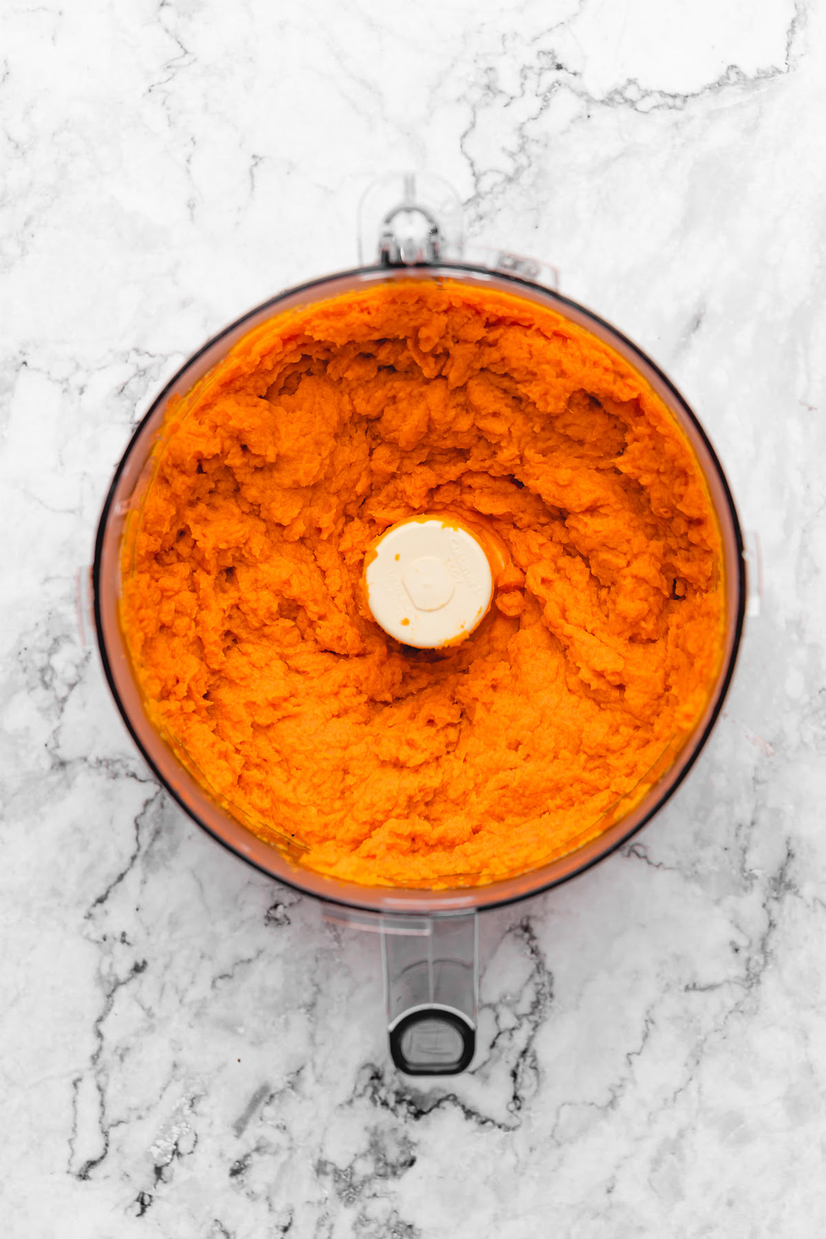 This Vegan Sweet Potato Pie is just like the Southern classic, but made without the dairy and eggs. Sweet, creamy, and perfect! Sweet potato puree in food processor bowl