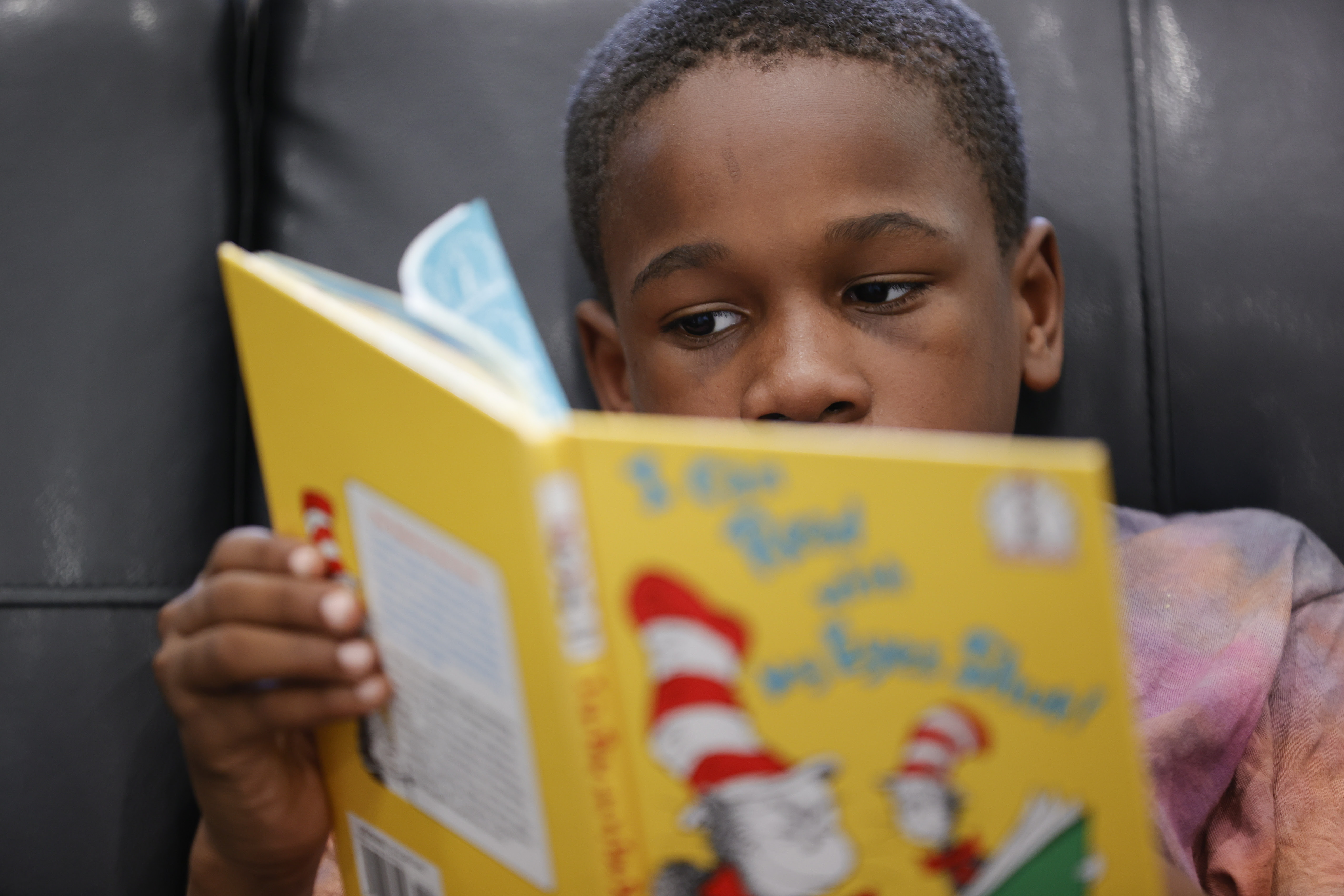 This image shows Michael Crowder, 11, reading during an after-school literacy program in Atlanta 