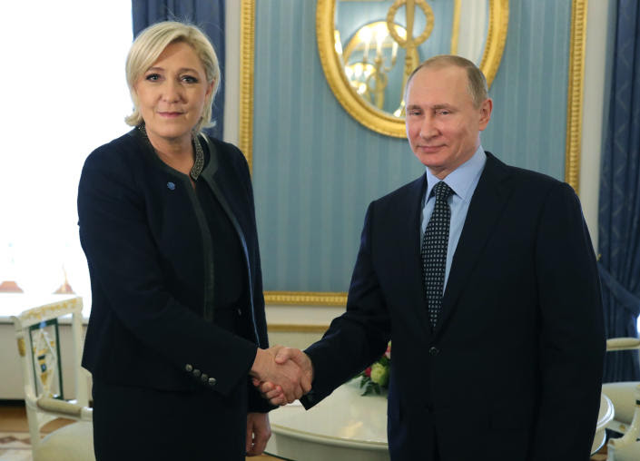 President Vladimir Putin wears an amused smile as Marine Le Pen, perhaps 3 inches taller than he is, looks disingenuously into the camera, in a magnificent stateroom decorated in turquoise and gilt.