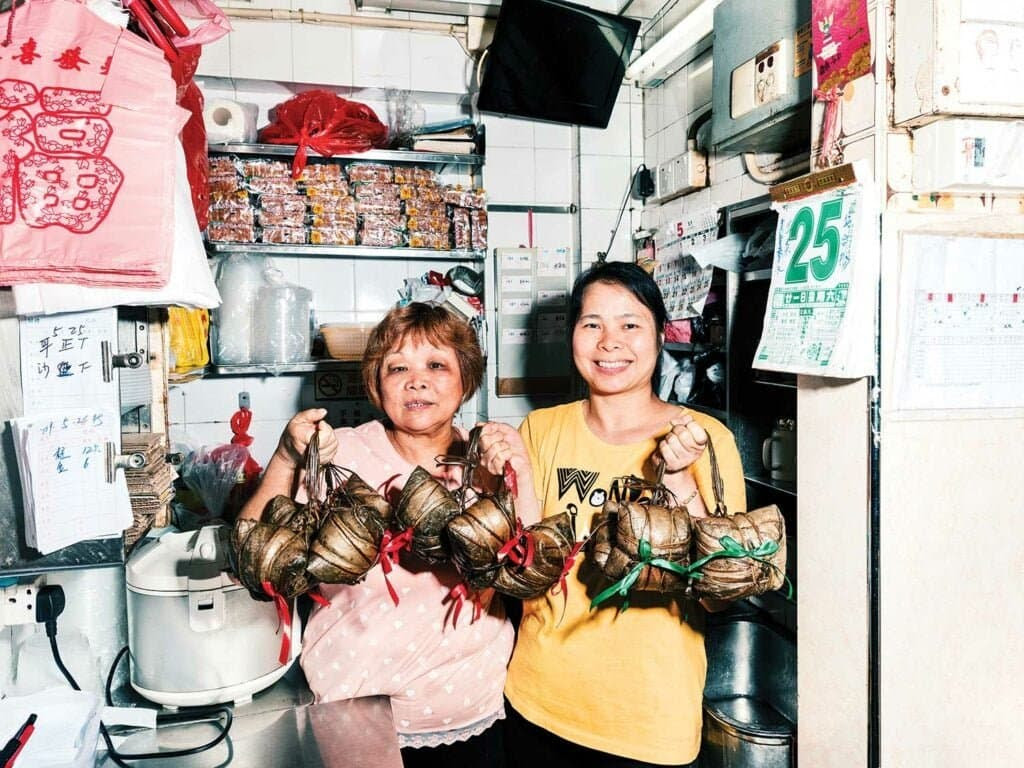 people holding up steamed food