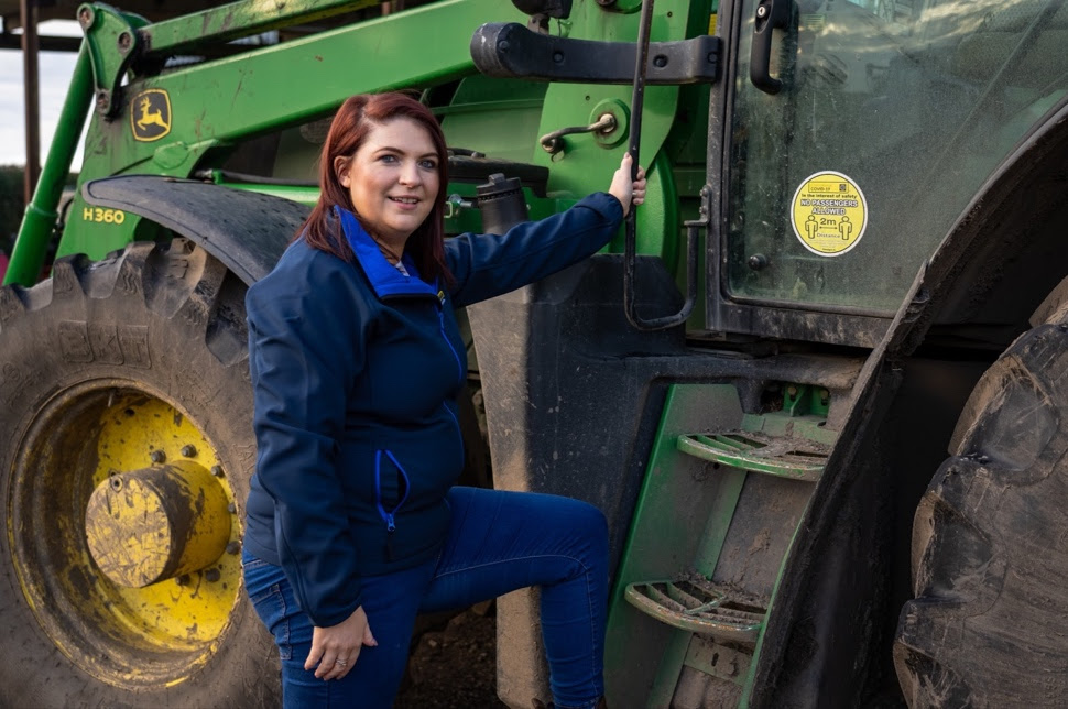 A person sitting on a tractor Description automatically generated with medium confidence