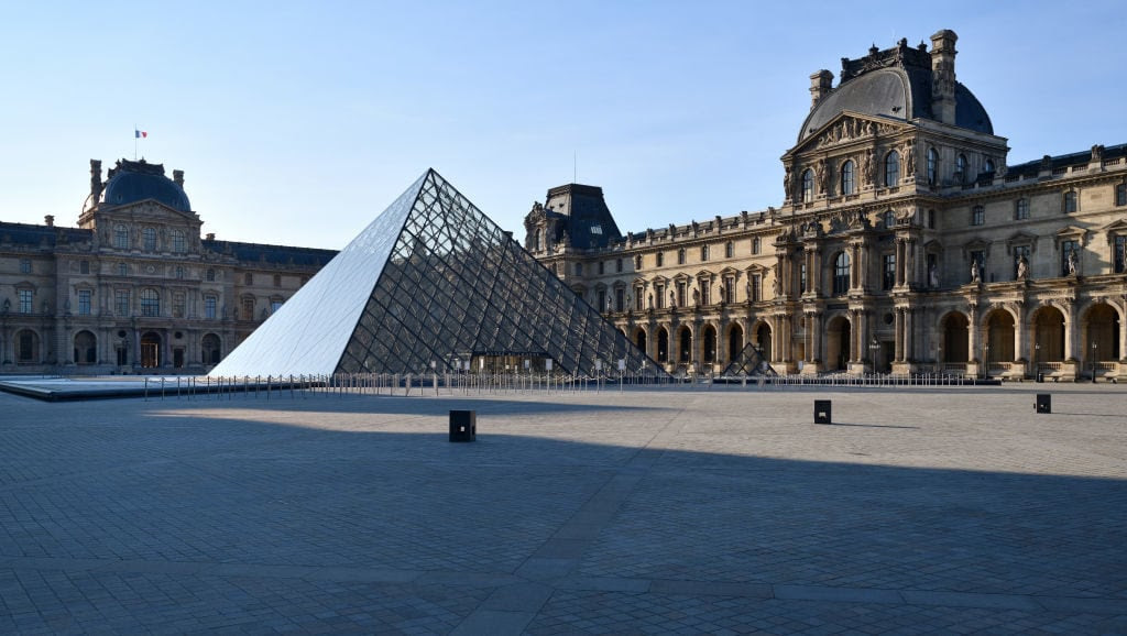 An unusually empty square in front of the Louvre museum during Paris's lockdown. Photo by Frédéric Soltan/Corbis via Getty Images.