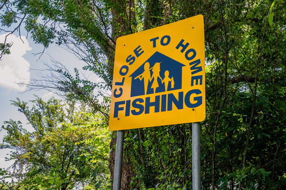 A Close to Home fishing sign in the park