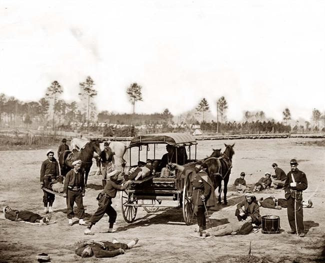 This is a stunning photograph from 1862. The image shows a Civil War Ambulance crew removing the wounded from a battlefiled. It shows a horse-drawn ambulance, and the Zouave uniforms of this unit.: