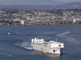 The USNS Mercy hospital ship leaves port Monday, March 23, 2020, in San Diego. The Navy hospital ship left San Diego on Tuesday and planned to spend a few days at sea getting its newly formed medical team used to working together before arriving to Los Angeles to help the city free up its hospital beds, in efforts to help combat the coronavirus. (AP Photo/Gregory Bull)