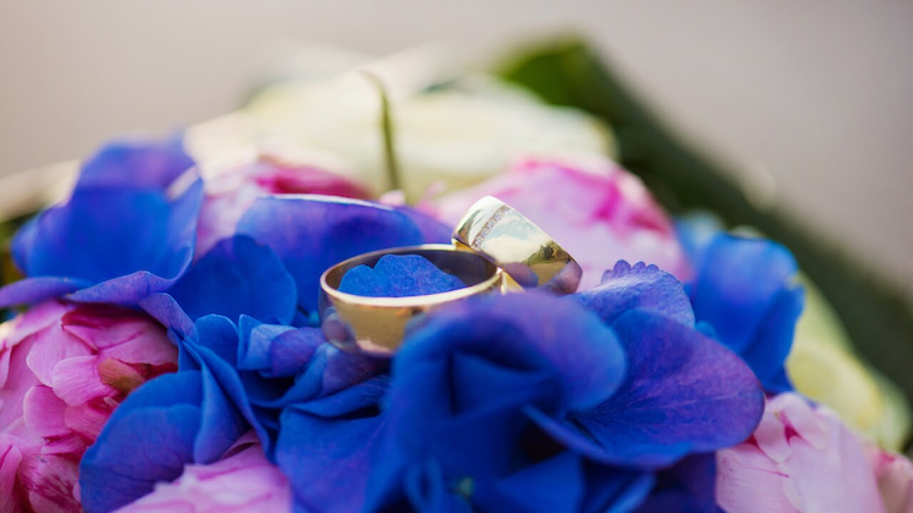 Wedding rings stacked together atop a bouquet Wedding rings stacked together atop a bouquet
