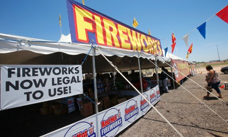 Customers walk into a  Red Hot Fireworks tent in Phoenix.