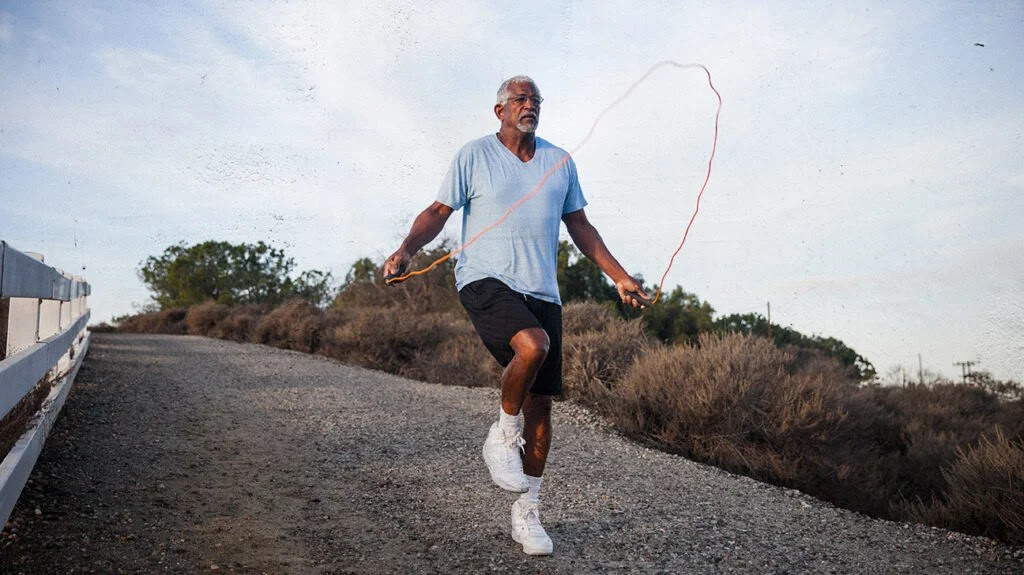 a man jumps rope outdoors, a good exercise to help lose weight after 50