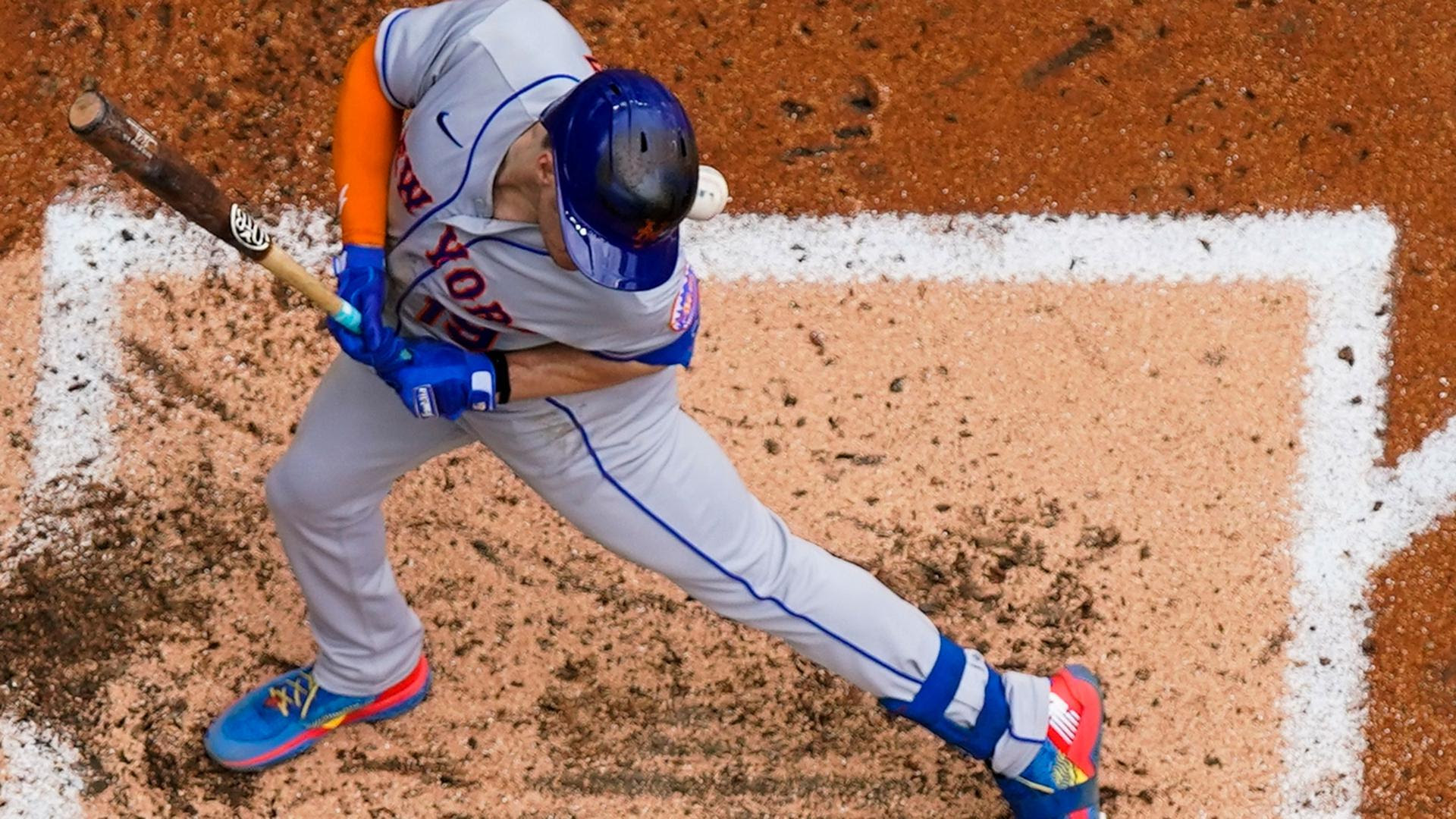 An overhead view of a Mets batter being hit by a pitch