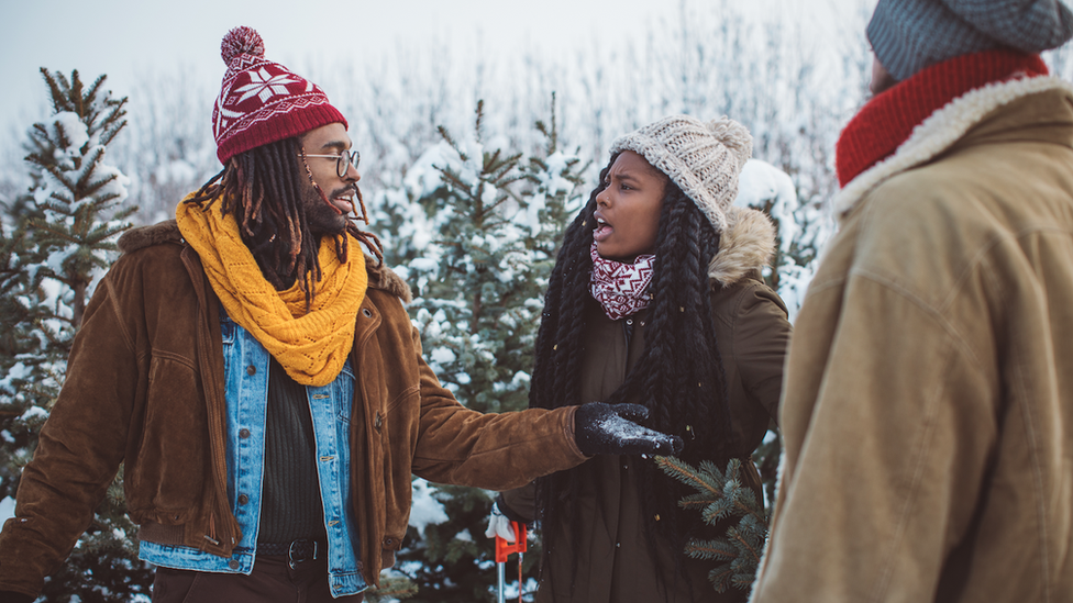 A man and a woman argue in the snow